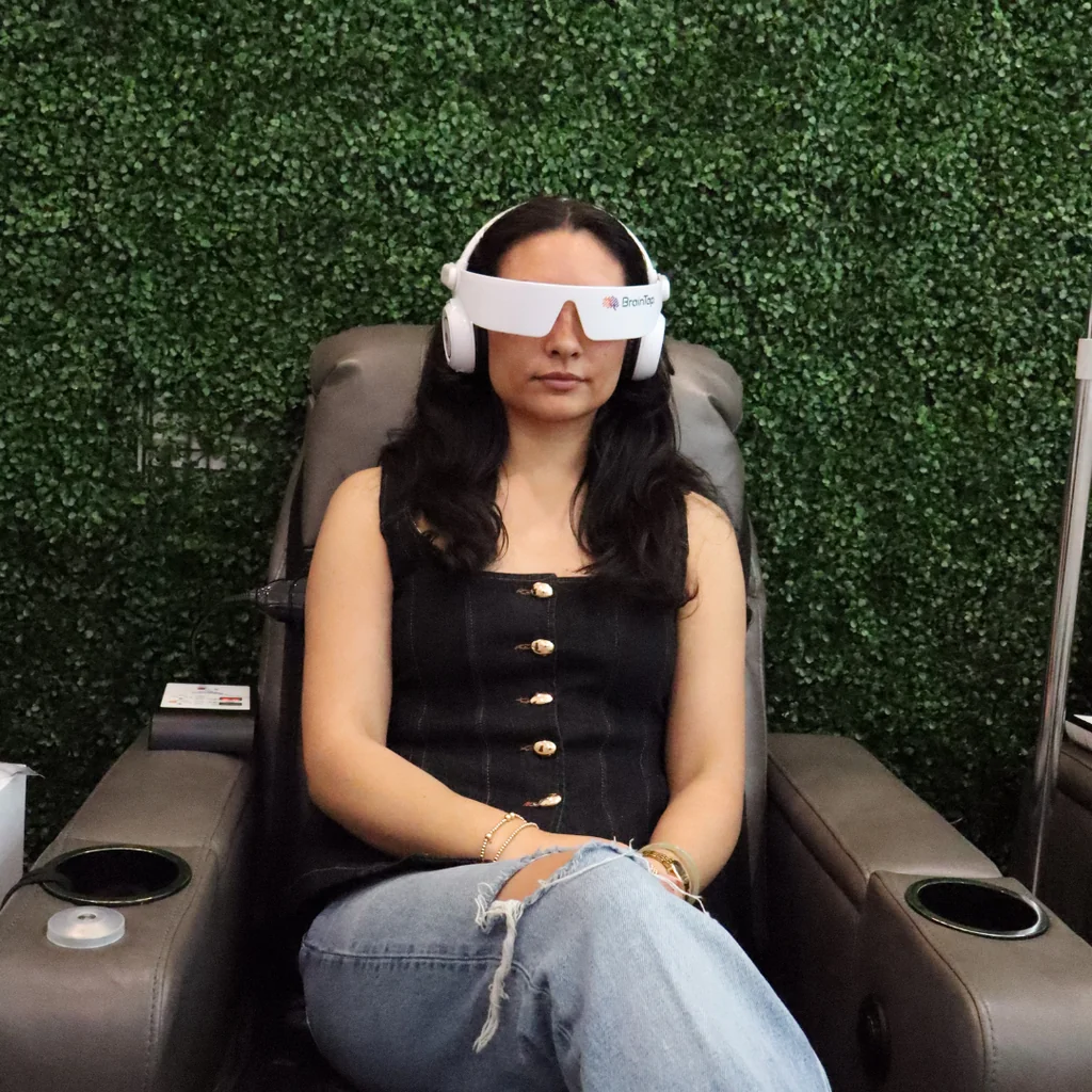 Patient relaxing during a BrainTap brainwave entrainment session at AARx